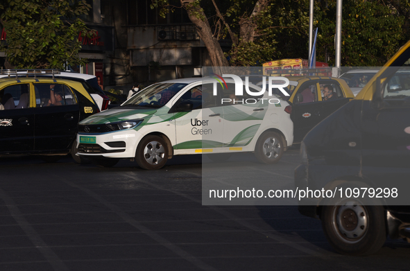 An electric Uber cab is driving through traffic in Mumbai, India, on February 8, 2024. 