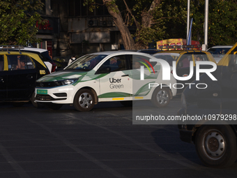 An electric Uber cab is driving through traffic in Mumbai, India, on February 8, 2024. (