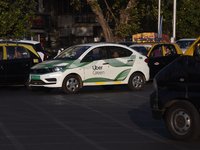 An electric Uber cab is driving through traffic in Mumbai, India, on February 8, 2024. (