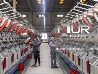 A textile worker is working at a production line of a chemical fiber company in Taizhou, China, on February 10, 2024. (