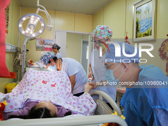 Medical staff and family members are accompanying a woman who is giving birth at the Maternal and Child Health Hospital in Zaozhuang, Shando...