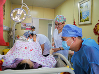 Medical staff and family members are accompanying a woman who is giving birth at the Maternal and Child Health Hospital in Zaozhuang, Shando...