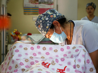 Medical staff and family members are accompanying a woman who is giving birth at the Maternal and Child Health Hospital in Zaozhuang, Shando...