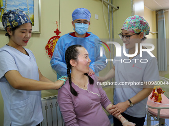 Medical staff and family members are accompanying a woman who is giving birth at the Maternal and Child Health Hospital in Zaozhuang, Shando...