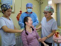 Medical staff and family members are accompanying a woman who is giving birth at the Maternal and Child Health Hospital in Zaozhuang, Shando...