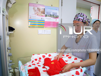 A medical worker is preparing newborn supplies at the maternity department of the Maternal and Child Health Hospital in Zaozhuang, Shandong...