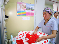 A medical worker is preparing newborn supplies at the maternity department of the Maternal and Child Health Hospital in Zaozhuang, Shandong...