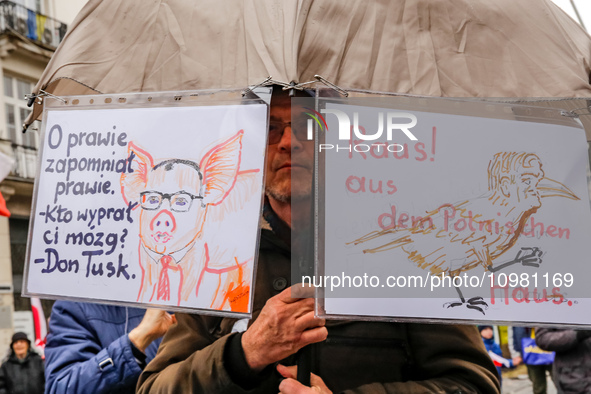 A man, holding anti-government banners, led by far right media - Gazeta Polska and TV Republica and Law and Justice (Prawo i Sprawiedliwość...