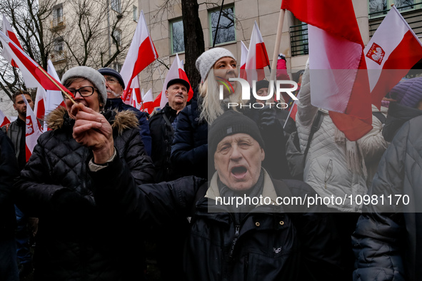 A crowd of people, holding Polish national flags, led by far right media - Gazeta Polska and TV Republica and Law and Justice (Prawo i Spraw...