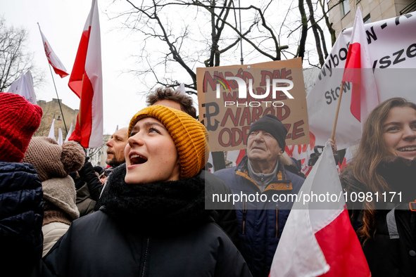 A crowd of people, holding Polish national flags and anti-government banners, led by far right media - Gazeta Polska and TV Republica and La...