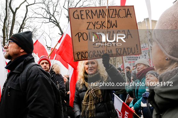 A crowd of people, holding Polish national flags and anti-government banners, led by far right media - Gazeta Polska and TV Republica and La...