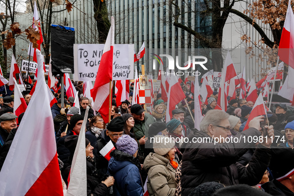 A crowd of people, holding Polish national flags and anti-government banners, led by far right media - Gazeta Polska and TV Republica and La...