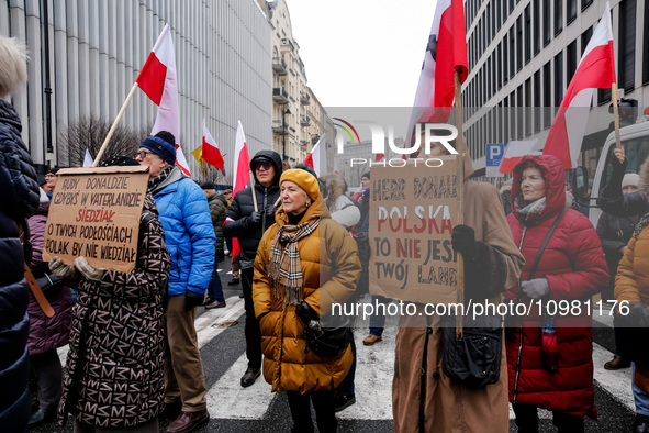 A crowd of people, holding Polish national flags and anti-government banners, led by far right media - Gazeta Polska and TV Republica and La...