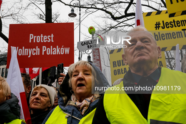 A crowd of people, holding Polish national flags and anti-government banners, led by far right media - Gazeta Polska and TV Republica and La...