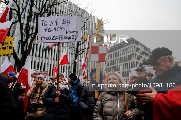 A crowd of people, holding Polish national flags and anti-government banners, led by far right media - Gazeta Polska and TV Republica and La...