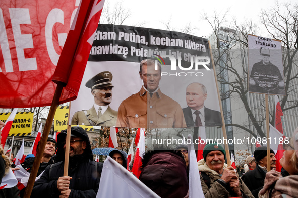 A crowd of people, holding Polish national flags and anti-government banners, led by far right media - Gazeta Polska and TV Republica and La...