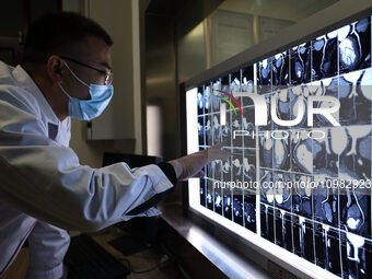 A doctor is checking a patient's CT scan in the imaging department of Boxing County Traditional Chinese Medicine Hospital in Binzhou, China,...