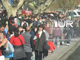 Crowds are gathering along the West Lake in Hangzhou, Zhejiang Province, China, on February 11, 2024. (