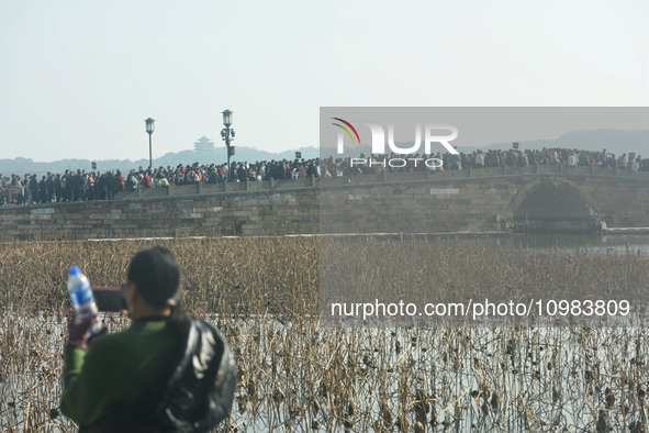 People are crowding on the broken West Lake Bridge in Hangzhou, Zhejiang Province, China, on February 11, 2024. 