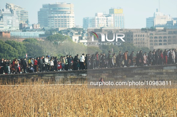 People are crowding on the broken West Lake Bridge in Hangzhou, Zhejiang Province, China, on February 11, 2024. 