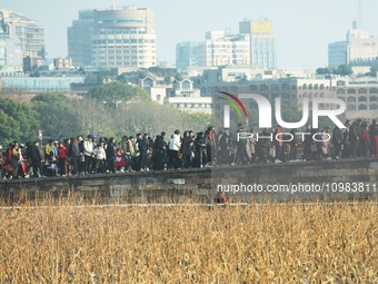 People are crowding on the broken West Lake Bridge in Hangzhou, Zhejiang Province, China, on February 11, 2024. (