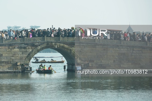 People are crowding on the broken West Lake Bridge in Hangzhou, Zhejiang Province, China, on February 11, 2024. 