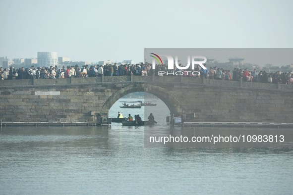 People are crowding on the broken West Lake Bridge in Hangzhou, Zhejiang Province, China, on February 11, 2024. 