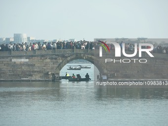 People are crowding on the broken West Lake Bridge in Hangzhou, Zhejiang Province, China, on February 11, 2024. (