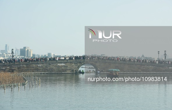 People are crowding on the broken West Lake Bridge in Hangzhou, Zhejiang Province, China, on February 11, 2024. 