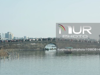 People are crowding on the broken West Lake Bridge in Hangzhou, Zhejiang Province, China, on February 11, 2024. (