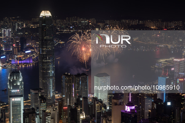 Fireworks are exploding over Victoria Harbour next to skyscrapers in Central in Hong Kong, on February 11, 2024. This is the first Lunar New...