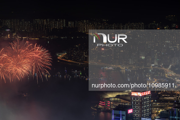 Fireworks are exploding over Victoria Harbour next to skyscrapers in Central in Hong Kong, on February 11, 2024. This is the first Lunar New...