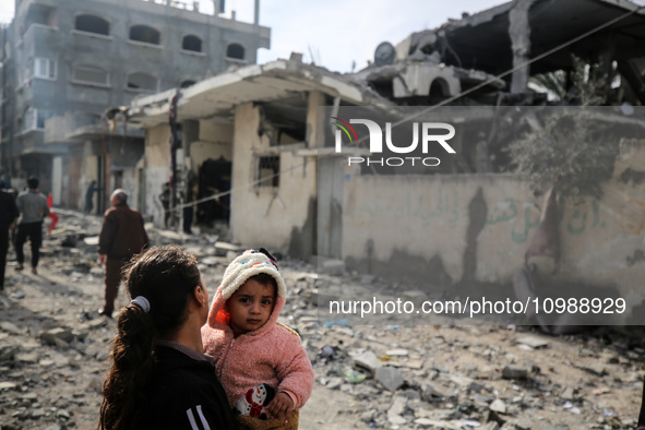 Palestinians are inspecting the damage caused by Israeli bombardment in Deir al-Balah, central Gaza Strip, on February 12, 2024, as battles...