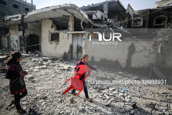 Palestinians are inspecting the damage caused by Israeli bombardment in Deir al-Balah, central Gaza Strip, on February 12, 2024, as battles...