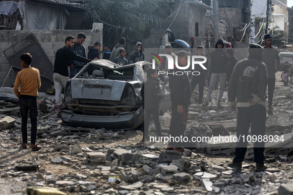 Palestinians are inspecting the damage caused by Israeli bombardment in Deir al-Balah, central Gaza Strip, on February 12, 2024, as battles...