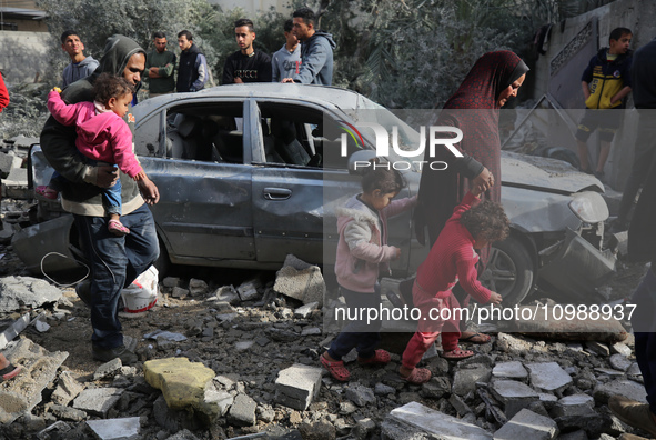 Palestinians are inspecting the damage caused by Israeli bombardment in Deir al-Balah, central Gaza Strip, on February 12, 2024, as battles...