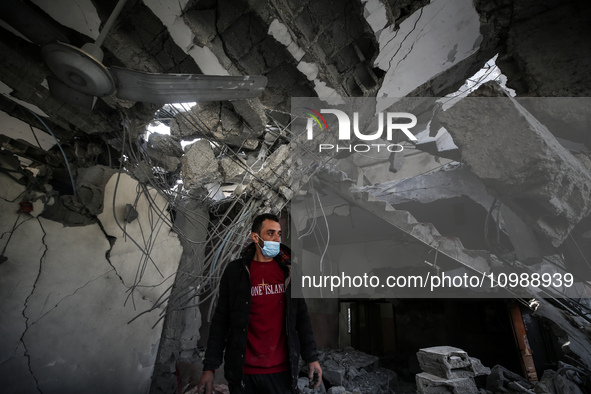 Palestinians are inspecting the damage caused by Israeli bombardment in Deir al-Balah, central Gaza Strip, on February 12, 2024, as battles...