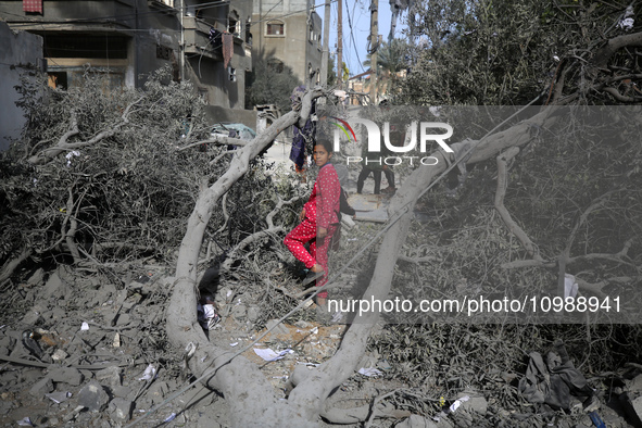 Palestinians are inspecting the damage caused by Israeli bombardment in Deir al-Balah, central Gaza Strip, on February 12, 2024, as battles...