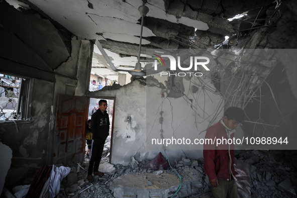 Palestinians are inspecting the damage caused by Israeli bombardment in Deir al-Balah, central Gaza Strip, on February 12, 2024, as battles...