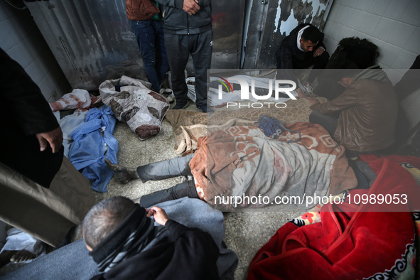 Palestinians are mourning their relatives, who were killed in an overnight Israeli strike on Deir al-Balah, during a mass funeral at the Al-...