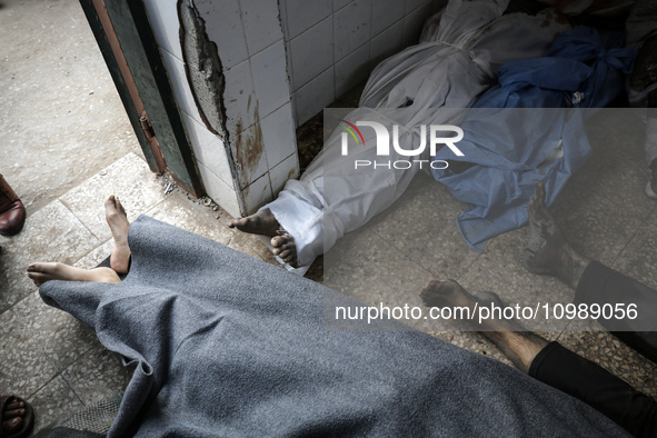 Palestinians are mourning their relatives, who were killed in an overnight Israeli strike on Deir al-Balah, during a mass funeral at the Al-...