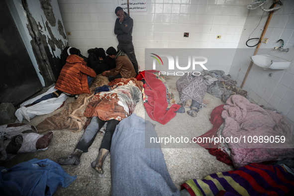 Palestinians are mourning their relatives, who were killed in an overnight Israeli strike on Deir al-Balah, during a mass funeral at the Al-...