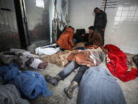 Palestinians are mourning their relatives, who were killed in an overnight Israeli strike on Deir al-Balah, during a mass funeral at the Al-...