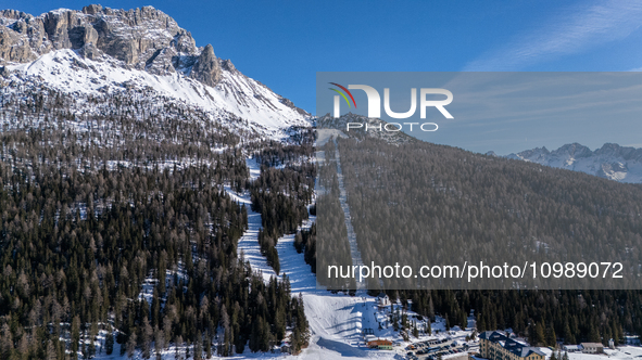 A drone view of the people skiing in Misurina-Col de Varda and the frozen Lake Misurina, blanketed in snow, in Misurina, Italy, on February...