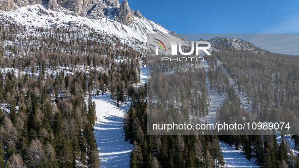 A drone view of the people skiing in Misurina-Col de Varda and the frozen Lake Misurina, blanketed in snow, in Misurina, Italy, on February...