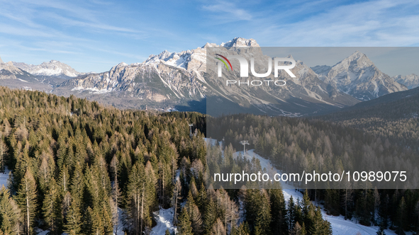 A drone view of a chairlift between the snow in Cortina d'Ampezzo, Italy, on February 4, 2024.  