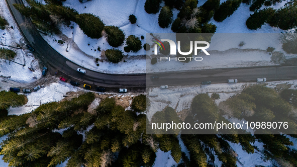 A drone view of a road between the snow in Cortina d'Ampezzo, Italy, on February 4, 2024.  