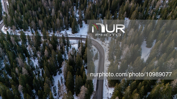 A drone view of a road between the snow in Cortina d'Ampezzo, Italy, on February 4, 2024.  