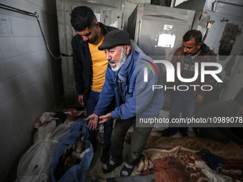 Palestinians are mourning their relatives, who were killed in an overnight Israeli strike on Deir al-Balah, during a mass funeral at the Al-...