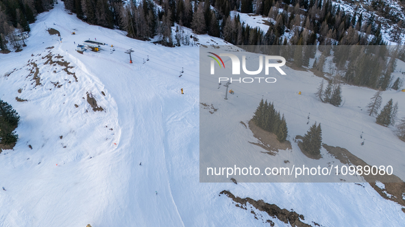 Aerial view of people skiing near Cortina d'Ampezzo, Italy, on February 4, 2024. A mild winter across Europe has resulted in several ski slo...